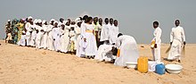 A Celestial Church of Christ baptism in Cotonou. 5% of Benin's population belongs to this denomination, an African Initiated Church. Benin - batism ceremony in Cotonou.jpg