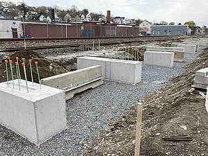 Completed pile caps at Fall River station, April 2021.jpg