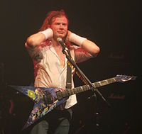 Metallica's original lead guitarist Dave Mustaine co-wrote a number of the band's early songs. Dave Mustaine at the Electric Ballroom in London.jpg