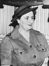 Black-and-white photograph of a dark-haired woman in a military uniform and wearing a hat