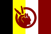 A black, yellow, white, and red flag with and image of a hand displaying a peace sign and the profile of a man's face.