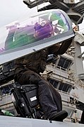 Flickr - Official U.S. Navy Imagery - NV native-Sailor cleans the cock pit canopy of an F-A-18 Hornet on the flight deck of USS Ronald Reagan.jpg