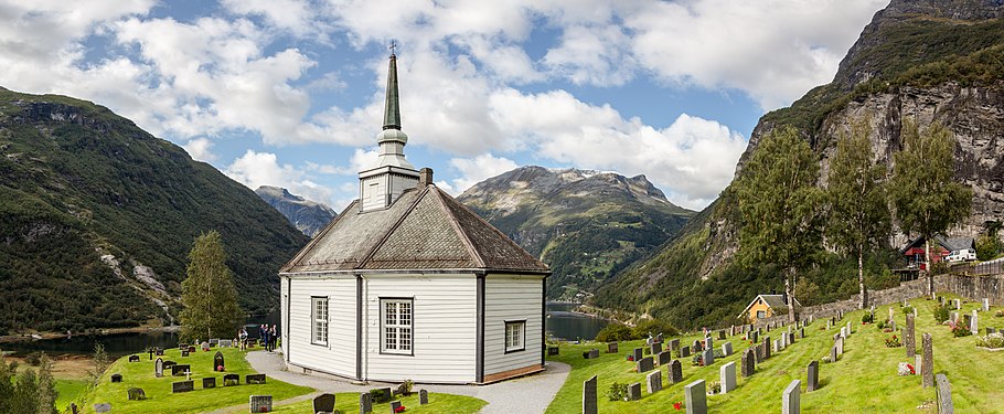 View of the Geiranger Church, the surrounding cemetery and the famous Geirangerfjord in the back.