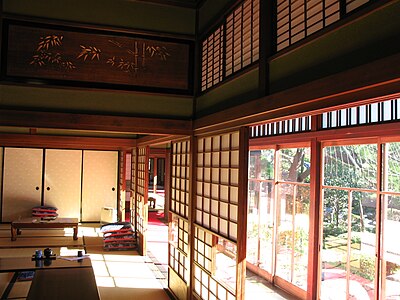Paper-coated nekoma shoji (with sliding sub-panel for view) inside the engawa, and all-glass garasu-do outside.