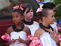 Young hula dancers wearing kukui nut lei in preparation for a performance on Molokai.