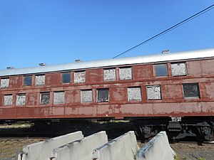 Red railway car with two levels of windows