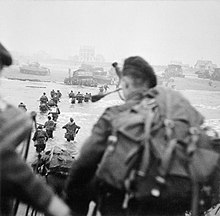 British Commandos wearing the green beret and carrying the Bergen rucksack during the Normandy landings Landing on Queen Red Beach, Sword Area.jpg