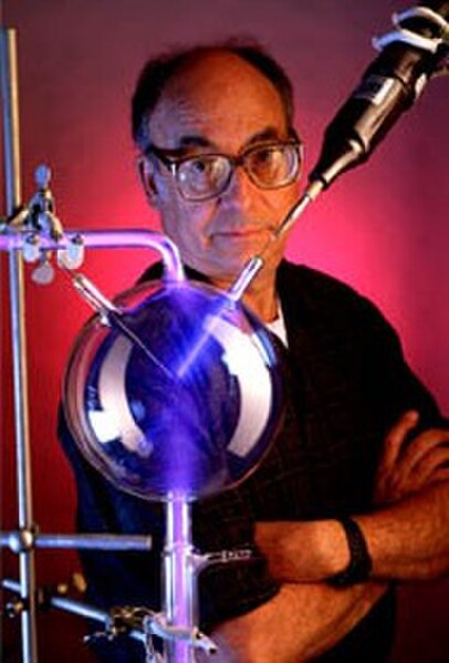 Stanley Miller in 1999, posed with an apparatus like that used in the original experiment