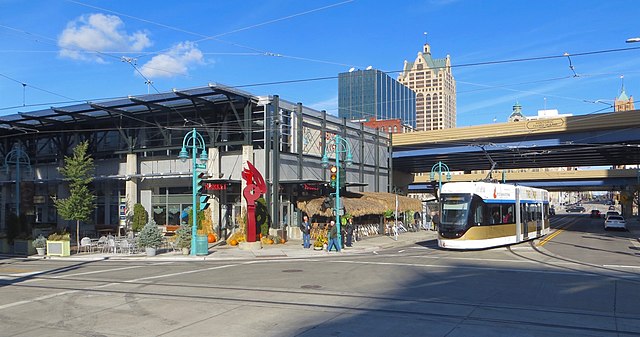 A Hop car turning from Broadway onto St. Paul Avenue, passing the Milwaukee Public Market