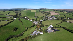 Molland, aerial panorama viewed from south. Far left: Great Champson, Middle Champson, Little Champson. Foreground: Copphall Molland Devon AerialPanorama.png