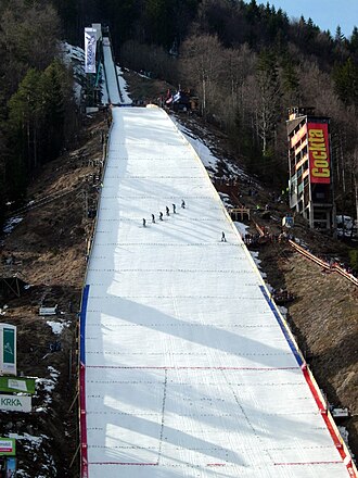 Letalnica Bratov Gorisek in Planica, Slovenia. The critical point is marked with a horizontal line at the top of the red vertical line, while the line at the bottom is the hill size point. Planica2Letalnica20080314.JPG