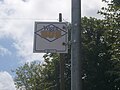 The bus stop flag at Shangri Lane, in the Broadway, Sandown, Isle of Wight, in June 2011. At the time it was served by Wightbus buses on route 22. From September 2011, the Isle of Wight Council axed all Wightbus operations and a replacement service is now run by Southern Vectis as service 24 run with volunteer drivers.