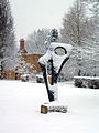 The statue outside the old porter's lodge in snow, "Achaean" by Barbara Hepworth.