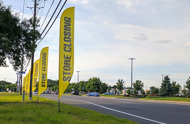 Store closing flags outside a Toys R Us in Deptford, New Jersey. Despite investments, the chain struggled to win market share in the age of digital co
