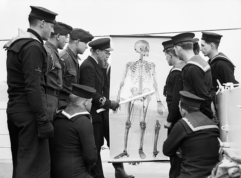 File:The ship's doctor giving a lecture on first aid to crew members on HMS ATHERSTONE at Plymouth, 7 March 1942. A7761.jpg