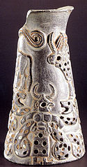 Vase from the Jiroft region. A "two horned" figure wrestling with serpents.