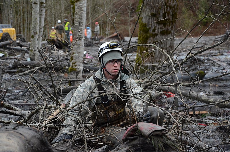 File:U.S. Air Force Staff Sgt. Jonathon Hernas, with the 141st Civil Engineering Squadron, Washington Air National Guard, carefully maneuvers across debris and mud while searching for missing persons in Oso, Wash 140328-Z-RI264-002.jpg