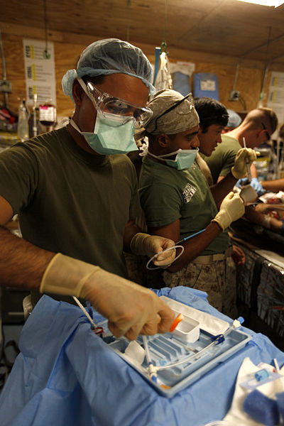 File:U.S. Navy Hospital Corpsman 1st Class Christian Diaz, front, a surgical technician assigned to a surgical platoon with Combat Logistics Regiment 2, helps Lt. Cmdr. Asheesh Kumar, center, an anesthesiologist with 130608-M-SA716-122.jpg