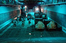 US Marines loading onto an LCAC within the well deck of USS Wasp, 2004 US Navy 040324-N-7586B-078 U.S. Marines assigned to the 22nd Marine Expeditionary Unit (Special Operations Capable) load onto an Landing Craft Air Cushion (LCAC) assigned to Assault Craft Unit Four (ACU 4).jpg