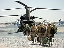 NMCB 11 boards a CH-47 Chinook for transport to Special Forces projects in Afghanistan 2009. US Navy 090421-N-1139L-003 Seabees assigned to Naval Mobile Construction Battalion (NMCB) 11 board a military helicopter for transportation to build Special Forces camps at undisclosed locations in Afghanistan.jpg