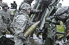 M107 projectile 155 mm projectile being loaded into an M777 howitzer 2 CR Field Artillery Range 141119-A-EM105-262.jpg
