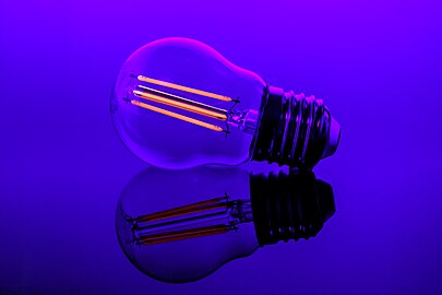 An LED filament light bulb in UV light