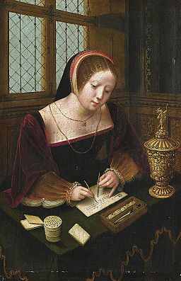 A lady writing at a desk