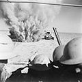 A mine explodes close to a British truck as it carries infantry through enemy minefields and wire to the new front lines.jpg