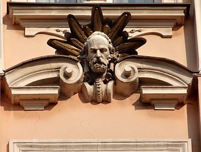 Head of architect Józef Święcicki among mascarons' facade