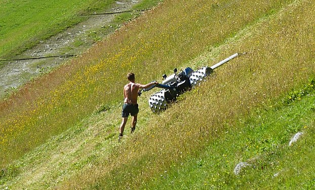 Swiss Mountain Farmer mowing meadow grass