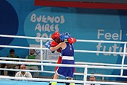 Deutsch: Boxen bei den Olympischen Jugendspielen 2018 Tag 12, 18. Oktober 2018 - Finale Fliegengewicht Mädchen – Martina La Piana (Italien, blau) schlägt Adijat Gbadamosi (Nigeria, rot) 5-0; Ringrichter ist James Beckles (Trinidad und Tobago). English: Boxing at the 2018 Summer Youth Olympics on 18 October 2018 – Girl's flyweight Gold Medal Bout - Martina La Piana (Italy, blue) beats Adijat Gbadamosi (Nigeria, red) 5-0; Referee is James Beckles (Trinidad and Tobago). Español: Boxeo en los Juegos Olímpicos Juveniles de Verano de 2018 en 18 de octubre de 2018 - Combate a medalla de oro de peso mosca para mujeres: Martina La Piana (Italia, azul) le gana a Adijat Gbadamosi (Nigeria, roja) 5-0; El árbitro es James Beckles (Trinidad y Tobago).