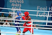 Deutsch: Boxen bei den Olympischen Jugendspielen 2018 Tag 12, 18. Oktober 2018 - Finale Fliegengewicht Mädchen – Martina La Piana (Italien, blau) schlägt Adijat Gbadamosi (Nigeria, rot) 5-0; Ringrichter ist James Beckles (Trinidad und Tobago). English: Boxing at the 2018 Summer Youth Olympics on 18 October 2018 – Girl's flyweight Gold Medal Bout - Martina La Piana (Italy, blue) beats Adijat Gbadamosi (Nigeria, red) 5-0; Referee is James Beckles (Trinidad and Tobago). Español: Boxeo en los Juegos Olímpicos Juveniles de Verano de 2018 en 18 de octubre de 2018 - Combate a medalla de oro de peso mosca para mujeres: Martina La Piana (Italia, azul) le gana a Adijat Gbadamosi (Nigeria, roja) 5-0; El árbitro es James Beckles (Trinidad y Tobago).