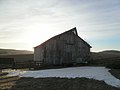 Drifted snow leads the way to the bank barn. (13512797643).jpg