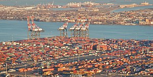 Ports play an important role in facilitating international trade. The Port of New York and New Jersey grew from the original harbor at the convergence of the Hudson River and the East River at the Upper New York Bay. Flight to Newark Liberty International Airport (EWR) with view to Newark Bay - panoramio.jpg