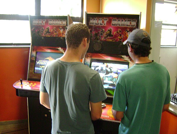 People playing an arcade game