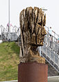 English: Sculpture 3 (out of three) of the arrangement "in flux" (2002) from the german sculptor Andreas Kuhnlein at the visitors park of the Munich Airport. He made his sculptures with a chain saw out of a piece from a tree. Deutsch: Skulptur 3 (von 3) des Arrangements "Im Fluss" (2002) des Bildhauers Andreas Kuhnlein im Besucherpark des Münchner Flughafens. Er formt seine Figuren mit der Kettensäge aus einem Baumstück.