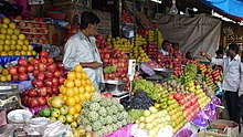 A market in Bangalore. Fruit stall at Bangalore City Market.jpg