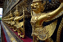 The statues of Krut battling naga serpent, a Thai Buddhist adaptation of Garuda in Wat Phra Kaeo temple, Thailand.