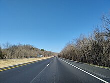 Driver's view of a straight, flat, four-lane divided highway