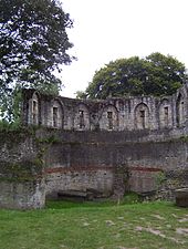 Les fenêtres étroites vues de l'intérieur des ruines de la tour.  L'herbe pousse le long des murs intérieurs.