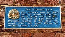 Plaque which states about King Edward II's burial at St Peter's Abbey King Edward's gate at Gloucester Cathedral.jpg