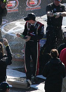 Kyle Larson formerly drove in the Sprint Cup Series for Ganassi. Kyle Larson celebrates 2012.jpg