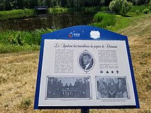 Poster evoking "The Paper Workers Union of Clermont" installed in front of a small lake at the municipal lake of Clermont, on the west bank of the Malbaie river, on the path of the bike path. Lac au parc municipal de Clermont-2018-07-20.jpg