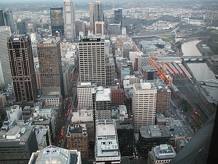 Aerial view of the city centre looking east. The Yarra River is on the right and the Melbourne Cricket Ground is in the background.