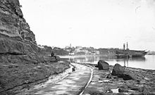 Point Britomart at the far right, seen from the east end of Official Bay, with Fort Britomart atop it.