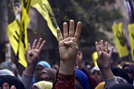 Protesters raise their hands with the four finger R4bia sign during a march in Maadi-Cairo on the six month anniversary of the violent crackdown against supporters of ousted President Morsi 14-Feb-2014.jpg
