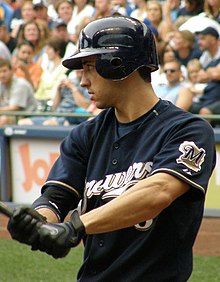 Ryan Braun, wearing a dark blue Brewers uniform, yields a baseball bat