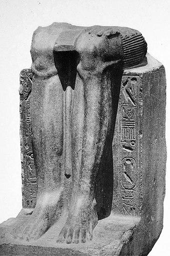 Remains of a statue of the Twelfth Dynasty reappropriated by Hyksos ruler "Khyan", with his name inscribed on the sides over an erasure.[156]