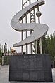 The monument commemorating the completion of en:Tarim Desert Highway, on the north side (in en:Luntai County)