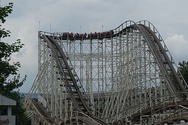 The red train of The Comet at Great Escape has ascended the first large "out" hill and is about to turn to the left to head "back"; the second "out an